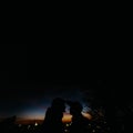 Silhouette of happy couple looking at each other and touching wi Royalty Free Stock Photo