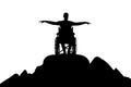 Silhouette of happy disabled man in wheelchair on top of mountain