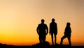 Silhouette of a happy family with arms raised up against beautiful sky. Summer Sunset Royalty Free Stock Photo