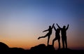 Silhouette of a happy family with arms raised up against beautiful sky. Summer Sunset Royalty Free Stock Photo