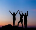 Silhouette of a happy family with arms raised up against beautiful sky. Summer Sunset Royalty Free Stock Photo