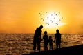 Silhouette of happy family on beach 1 Royalty Free Stock Photo