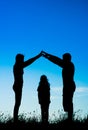 Silhouette of a happy family making the home sign Royalty Free Stock Photo