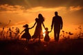 Silhouette of a happy family at sunset in the meadow, Silhouette of young couple hiker were standing at the top of the mountain Royalty Free Stock Photo