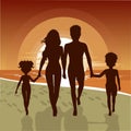 Silhouette of happy family walking along beach at sunset