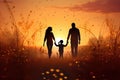 Silhouette of a happy family walking in the field at sunset, Silhouettes of happy family holding the hands in the meadow during Royalty Free Stock Photo