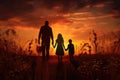 Silhouette of a happy family walking in the field at sunset, Silhouettes of happy family holding the hands in the meadow during Royalty Free Stock Photo