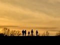 Silhouette of a happy family walking in the meadow during a scenic sunset Royalty Free Stock Photo