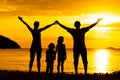 Silhouette of happy family who playing on the beach Royalty Free Stock Photo