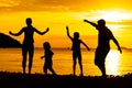 Silhouette of happy family who playing on the beach Royalty Free Stock Photo