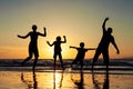 Silhouette of happy family who standing on the beach at the suns Royalty Free Stock Photo