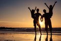 Silhouette of happy family who standing on the beach at the suns Royalty Free Stock Photo