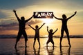 Silhouette of happy family who standing on the beach at the suns Royalty Free Stock Photo