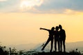 Silhouette of happy friends  in sunset sky evening time background,  Group of young people having fun on summer vacation,  Youth Royalty Free Stock Photo