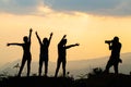 Silhouette of happy friends  in sunset sky evening time background,  Group of young people having fun on summer vacation,  Youth Royalty Free Stock Photo