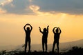 Silhouette of happy friends  in sunset sky evening time background,  Group of young people having fun on summer vacation,  Youth Royalty Free Stock Photo