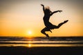 Silhouette of a happy beautiful dancer girl at sunset Royalty Free Stock Photo