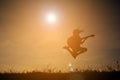Silhouette happy girl playing guitar at the sky sunset, happy ti Royalty Free Stock Photo