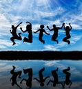 Silhouette of a happy group of people jumping