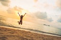 Silhouette of happy joyful woman jumping at the beach against the sunset Royalty Free Stock Photo