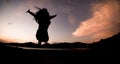 Silhouette, happy jumping Shadow girl Jump on the orange sky in the evening Royalty Free Stock Photo