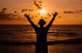 Silhouette of Happy man raise up hands on sunset at sea,Freedom concept Royalty Free Stock Photo