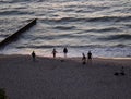 Silhouette of happy people on the Shore Sunset time young woman from the back