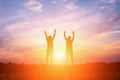 Silhouette of happy people making high hands