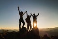 Silhouette of happy teamwork with success gesture standing on the top of mountain, business teamwork concept, business victory, Royalty Free Stock Photo