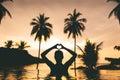 Silhouette of happy traveller asian woman relax in luxury pool resort on beach at sunset in summer Thailand Royalty Free Stock Photo