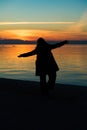 Silhouette of happy woman against beautiful after sunset color tone Royalty Free Stock Photo