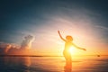 Silhouette of woman dancing in the ocean at sunset Royalty Free Stock Photo