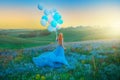 Silhouette happy woman. Fantasy girl princess holding in hand ball air balloon. long blue tulle dress fluttering fly in