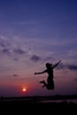 Silhouette happy woman jumping against beautiful in sunset. Free Royalty Free Stock Photo