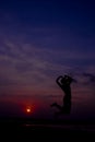 Silhouette happy woman jumping against beautiful in sunset. Free Royalty Free Stock Photo