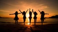 silhouette of happy women friends dancing at beach party at sunset, joyful group of female celebrate on vacation Royalty Free Stock Photo