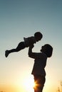 Silhouette of a woman with her child at sunset. Royalty Free Stock Photo