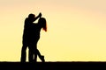 Silhouette of Happy Young Couple Dancing at Sunset Royalty Free Stock Photo