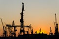 Silhouette of harbour cranes and container terminal during scenic sunset in Hamburg, Germany Royalty Free Stock Photo