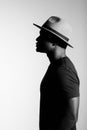 Silhouette head of sad african american man in hat on black and white isolated background Royalty Free Stock Photo