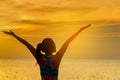 Silhouette healthy woman lifestyle relaxing and exercising vital meditate and practicing yoga on the beach at sunset Royalty Free Stock Photo