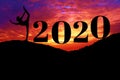 Silhouette of healthy woman practicing yoga on the hill and 2020 years with sky twilight. concept celebrating new year Royalty Free Stock Photo