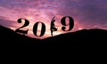 Silhouette of healthy woman practicing yoga on the hill and 2019 years with sky twilight. concept celebrating new year Royalty Free Stock Photo