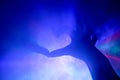 Silhouette of the heart in disco rays in the smoke Royalty Free Stock Photo