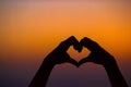 Silhouette of heart made hands at sunset Royalty Free Stock Photo