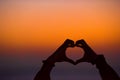 Silhouette of heart made hands at sunset Royalty Free Stock Photo