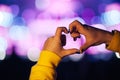 Silhouette of a heart shaped hands and crowd of Audience at live concert, light illuminated is power of music concert Royalty Free Stock Photo