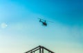 Silhouette of helicopter in blue clear sky with solar patches of light. Warm spring day. Modern transport. Royalty Free Stock Photo