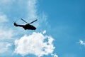 Silhouette of a helicopter flying against the blue sky background Royalty Free Stock Photo
