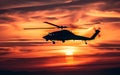 A silhouette of a helicopter flying against the vibrant hues of a sunset sky, emanating a sense of freedom and adventure Royalty Free Stock Photo